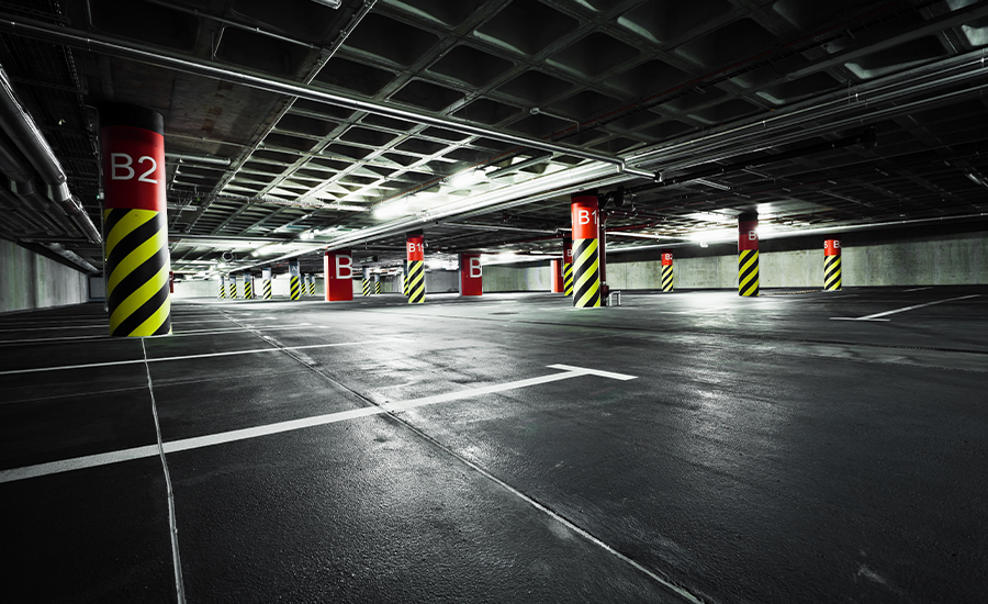 Secure airport parking lot with bright lighting, CCTV surveillance, gated entry, and staff patrols